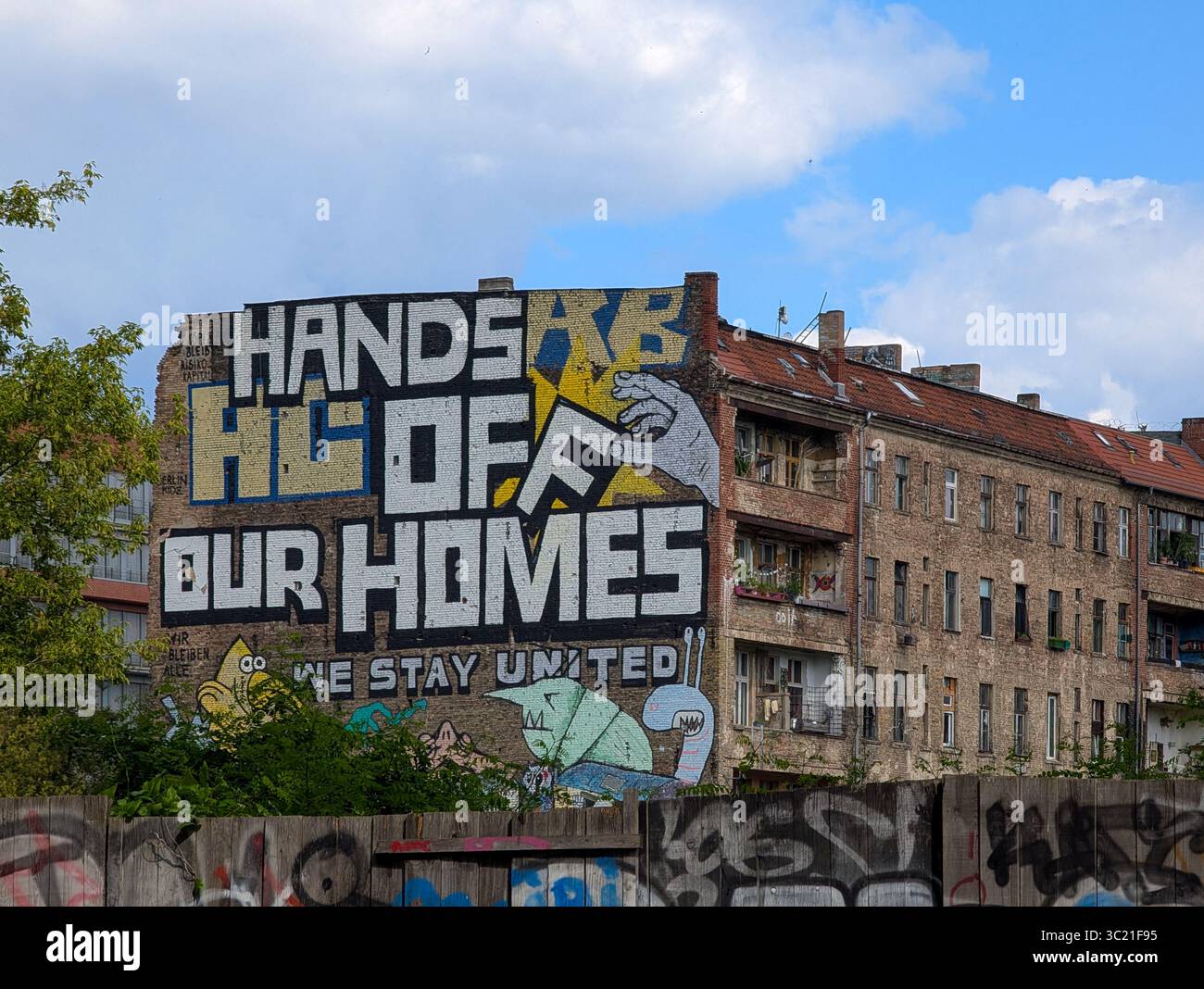 A large protest mural on the side of the alternative housing project ...