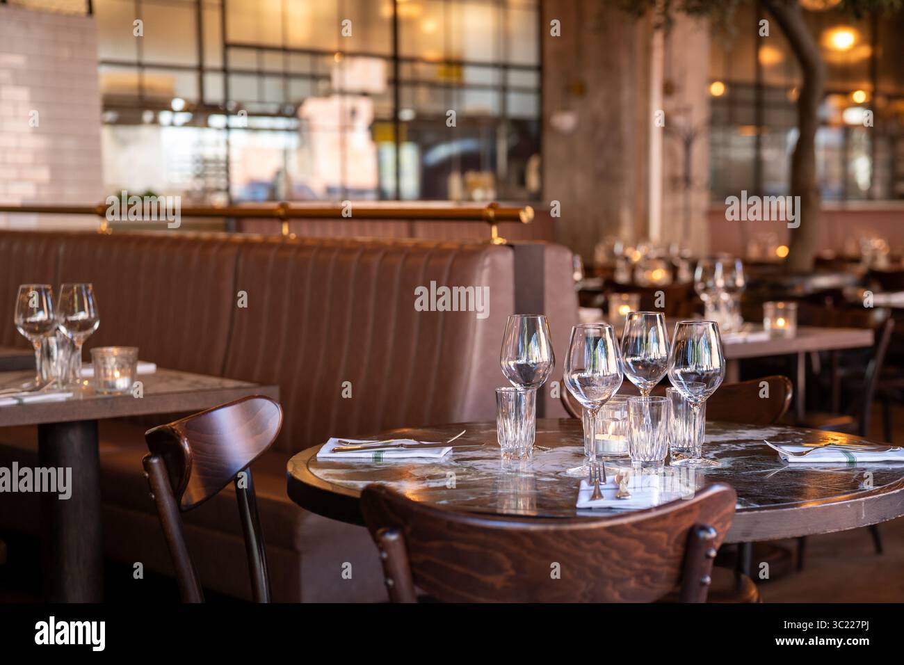 Elegant Restaurant Interior with Table Set for Dinner Stock Photo