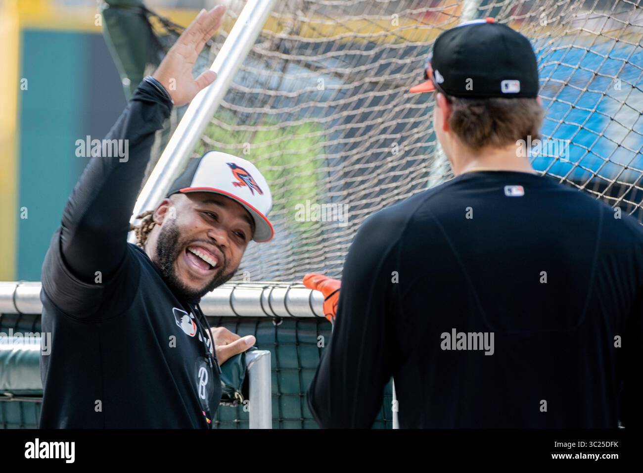 Baltimore Orioles hitting coach Sherman Johnson, left, jokes with Coby ...