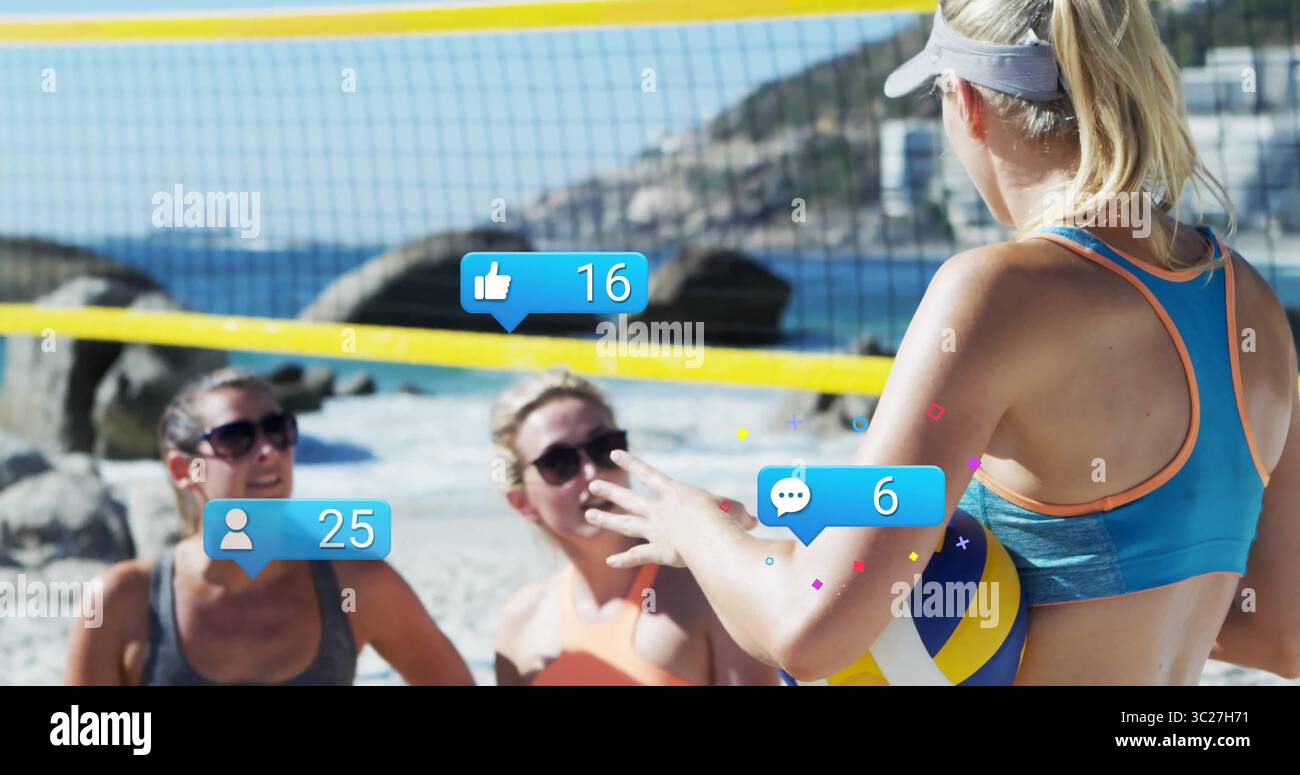 Female player wearing blue tank grey visor serving volleyball on beach with yellow net, copy space Stock Photo