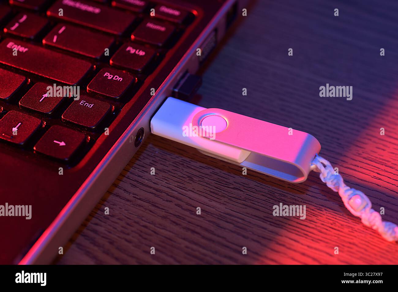 Flash drive plugged into the USB port of a laptop computer Stock Photo