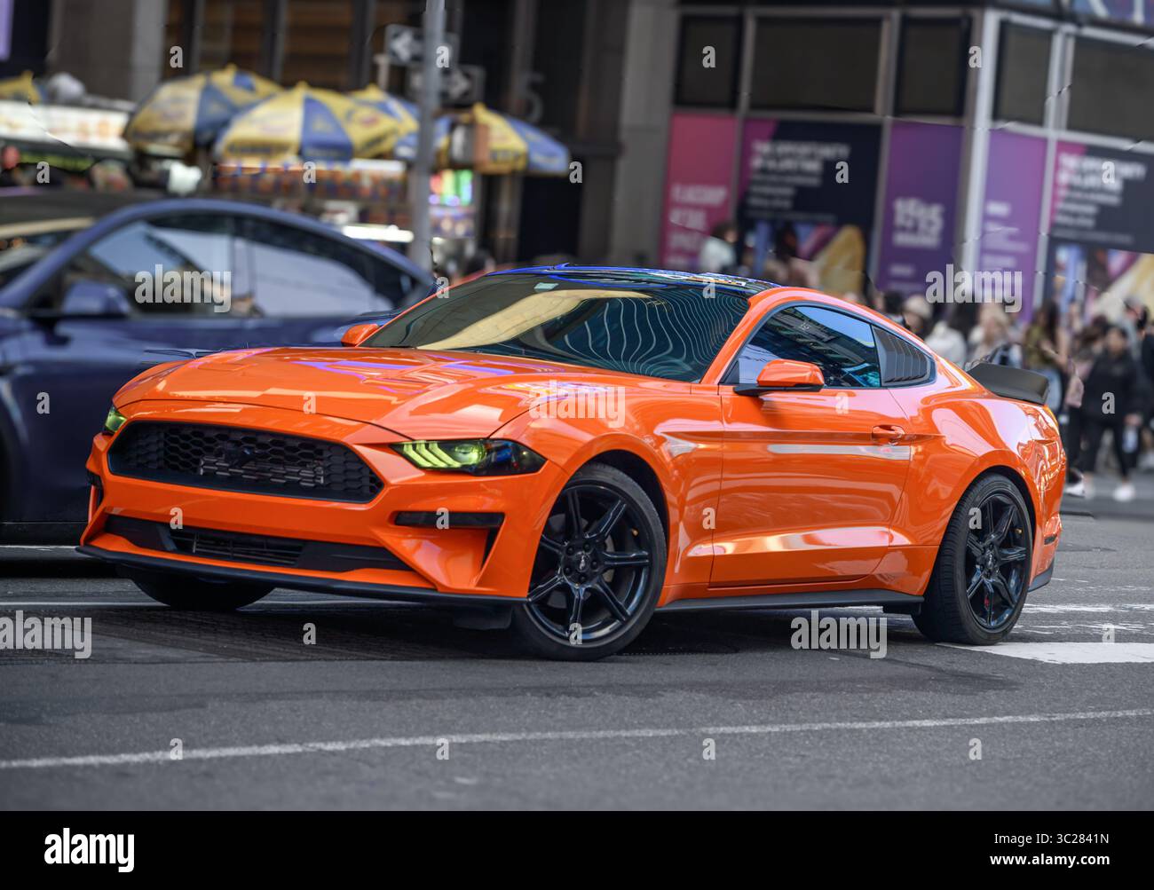 An Orange Ford Mustang, Sixth Generation, Travels On 7th Ave New York ...