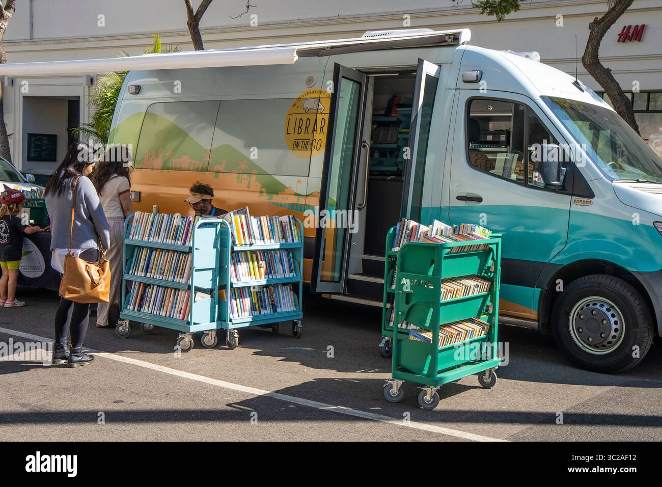 The 'Library on the go' from the Santa Barbara Library to bring books to people, especially kids. This library is at the Tuesday Farmer's Market. Stock Photo