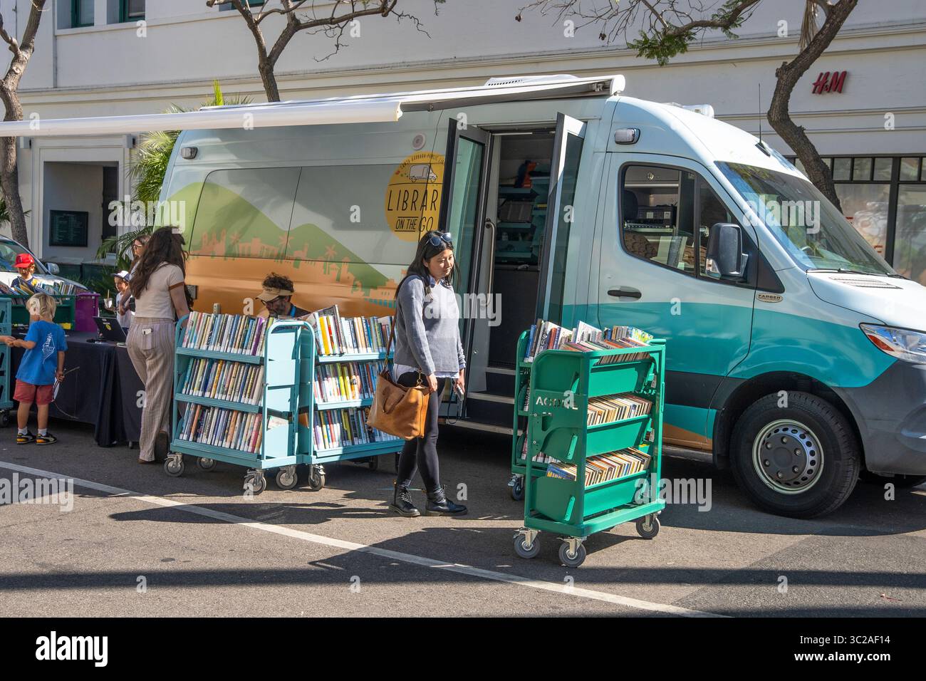 The 'Library on the go' from the Santa Barbara Library to bring books to people, especially kids. This library is at the Tuesday Farmer's Market. Stock Photo