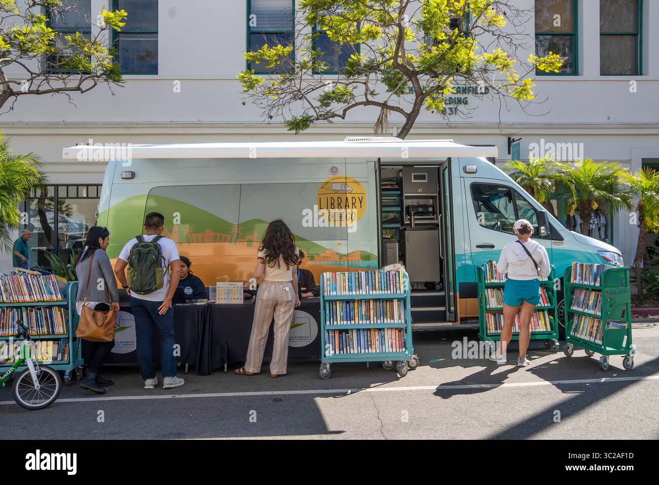 The 'Library on the go' from the Santa Barbara Library to bring books to people, especially kids. This library is at the Tuesday Farmer's Market. Stock Photo