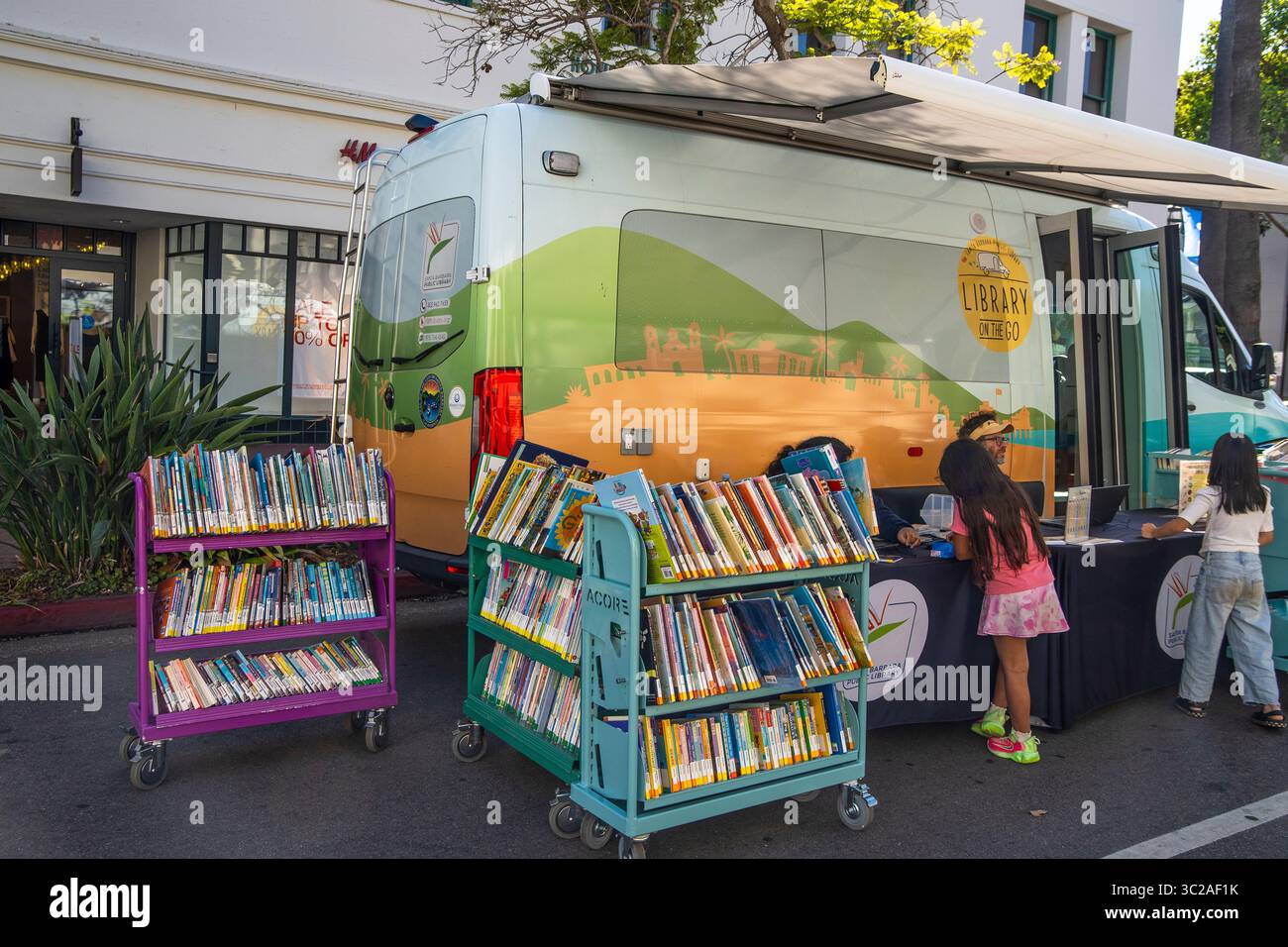 The 'Library on the go' from the Santa Barbara Library to bring books to people, especially kids. This library is at the Tuesday Farmer's Market. Stock Photo