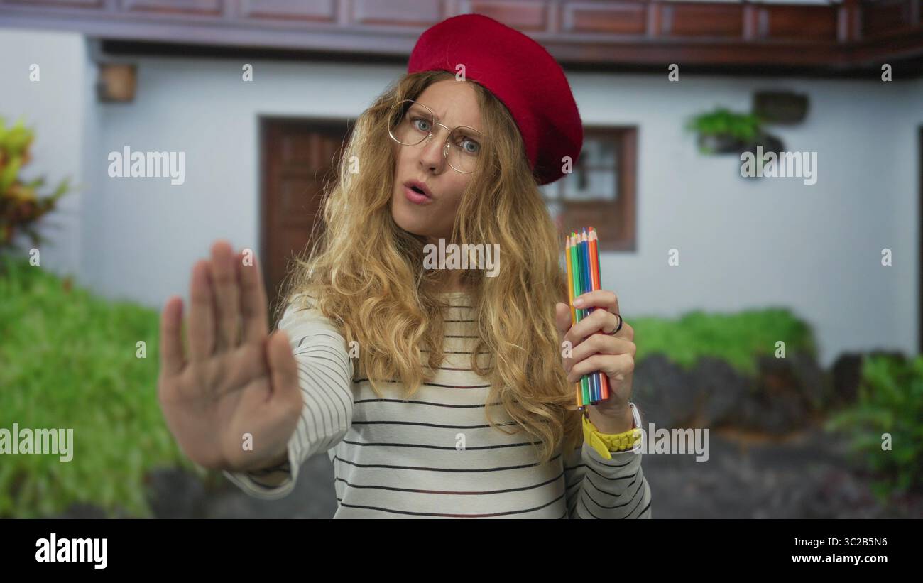 Woman holds pencils signals stop hi-res stock photography and images ...