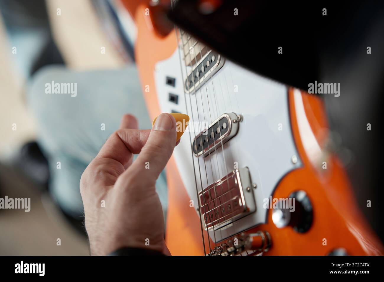 Close up view of a person skillfully playing an electric guitar Stock Photo