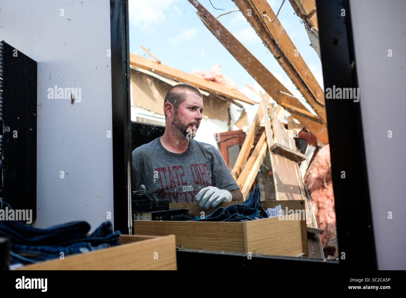 May 27, 2019 - Dayton, Ohio, United States - Adam removes personal belongings from his childhood home that was struck by a tornado the night before..At least 1 person is dead and 12 injured from the storms that hit western Ohio. (Credit Image: © Megan Jelinger/SOPA Images via ZUMA Wire) Stock Photo