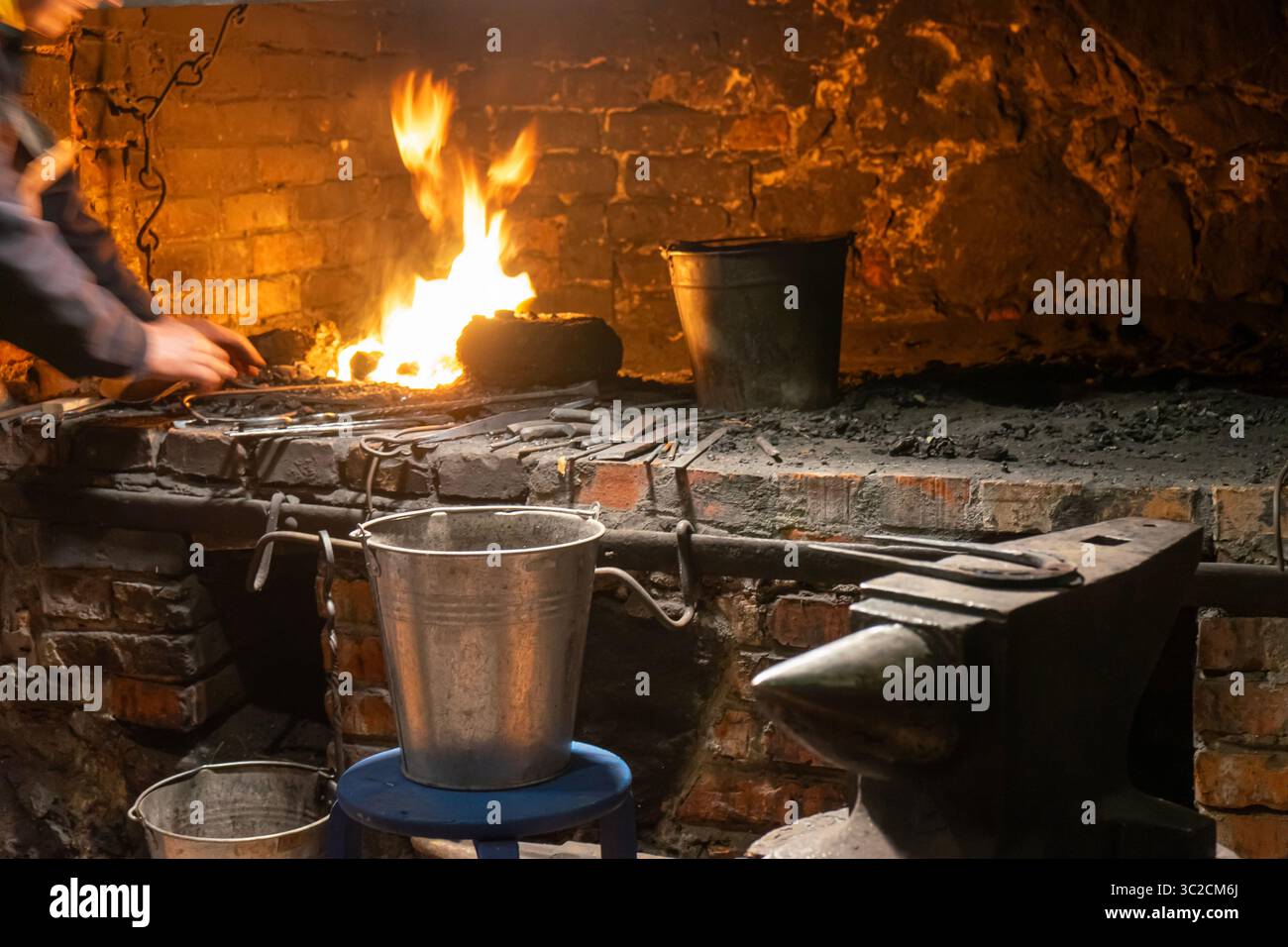 A master blacksmith at work, forging history with fire and steel in a ...
