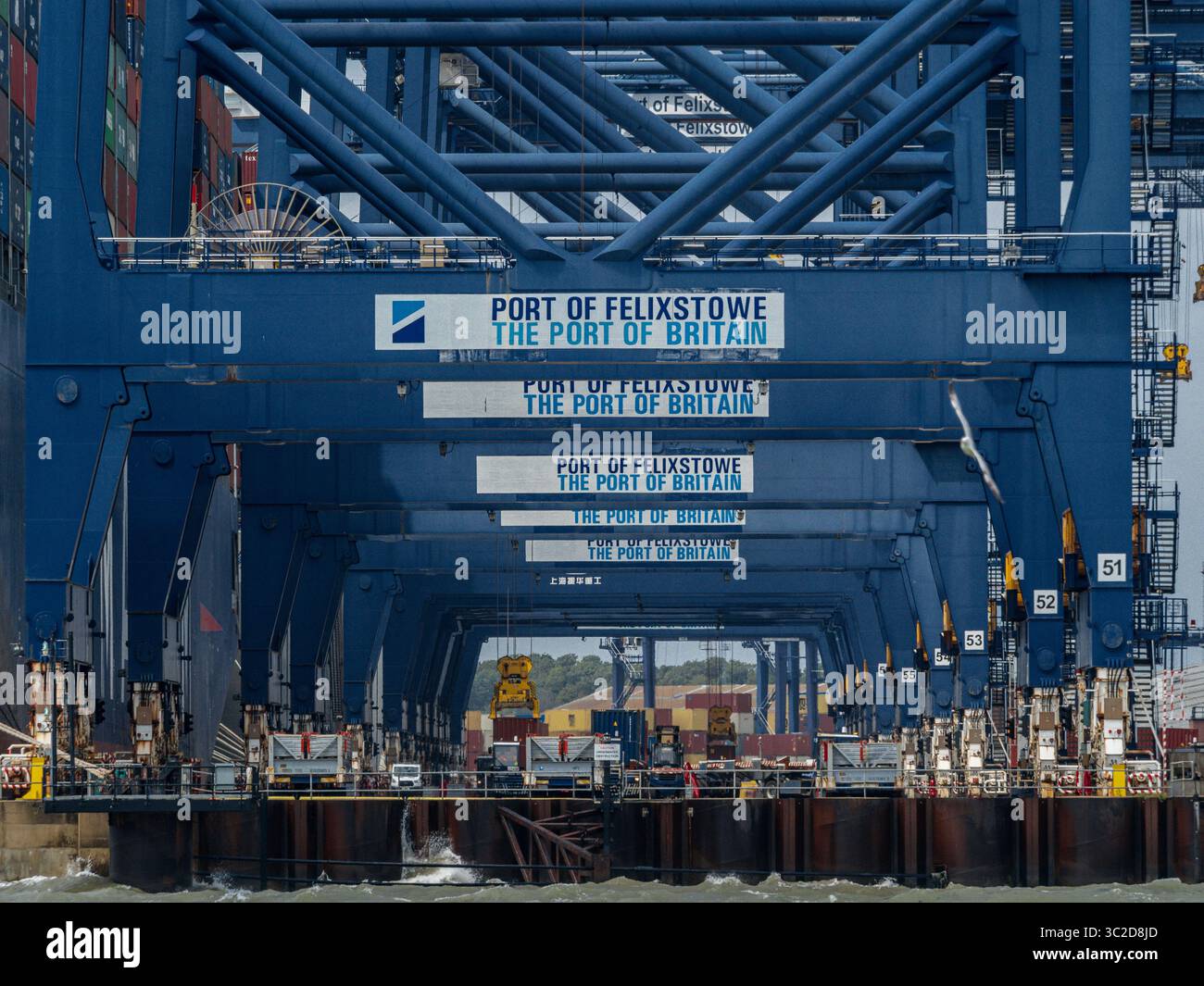 Felixstowe Port - cranes loading and unloading containers from vessels at the Port of Felixstowe, the largest container port in the UK. Stock Photo