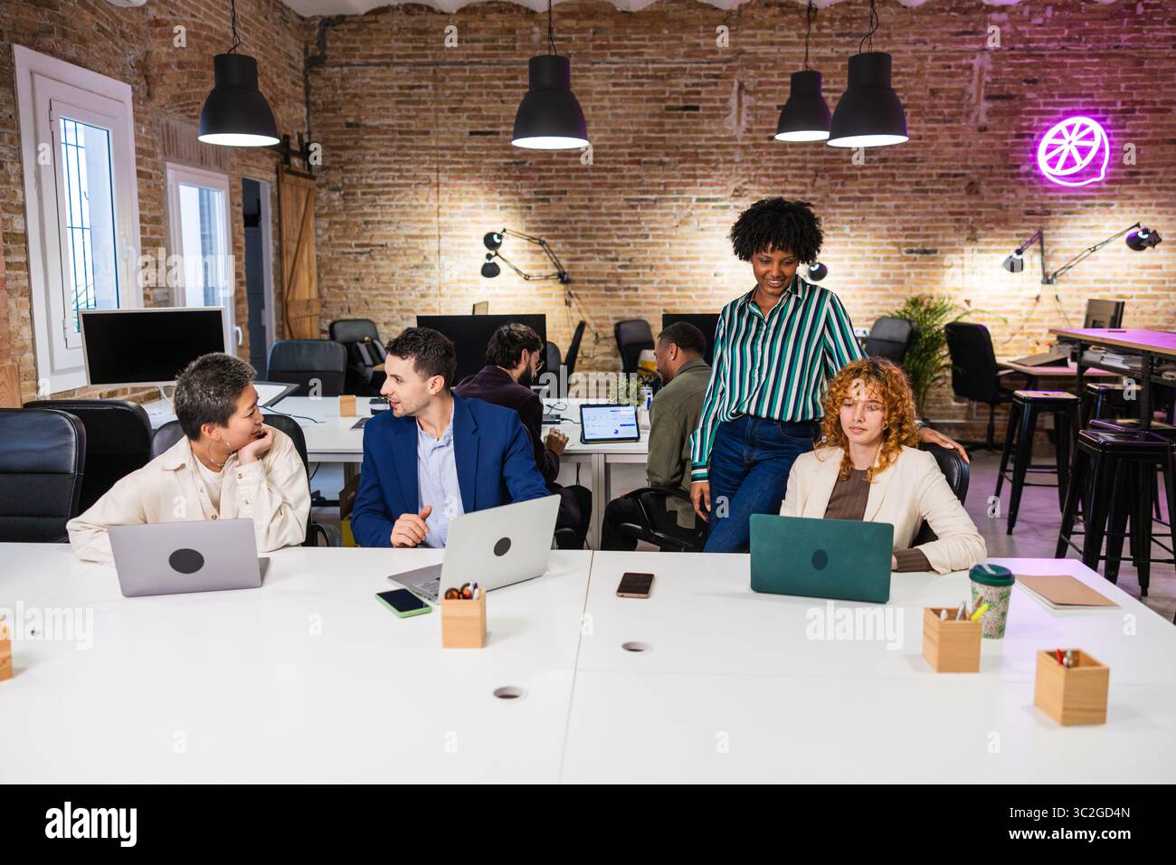 Multi ethnic team collaborating on project in modern office Stock Photo