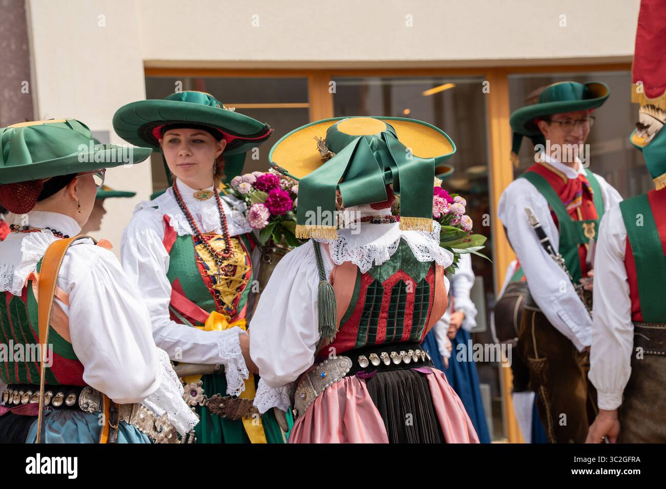 Group of women wearing traditional tracht and dirndl dress costumes during Ladin village summer festival procession in Val Gardena Stock Photo