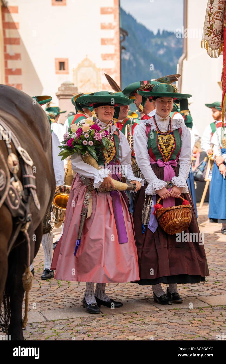 Pair of women wearing traditional tracht and dirndl dress costumes during  Ladin village summer festival procession in Val Gardena Stock Photo - Alamy