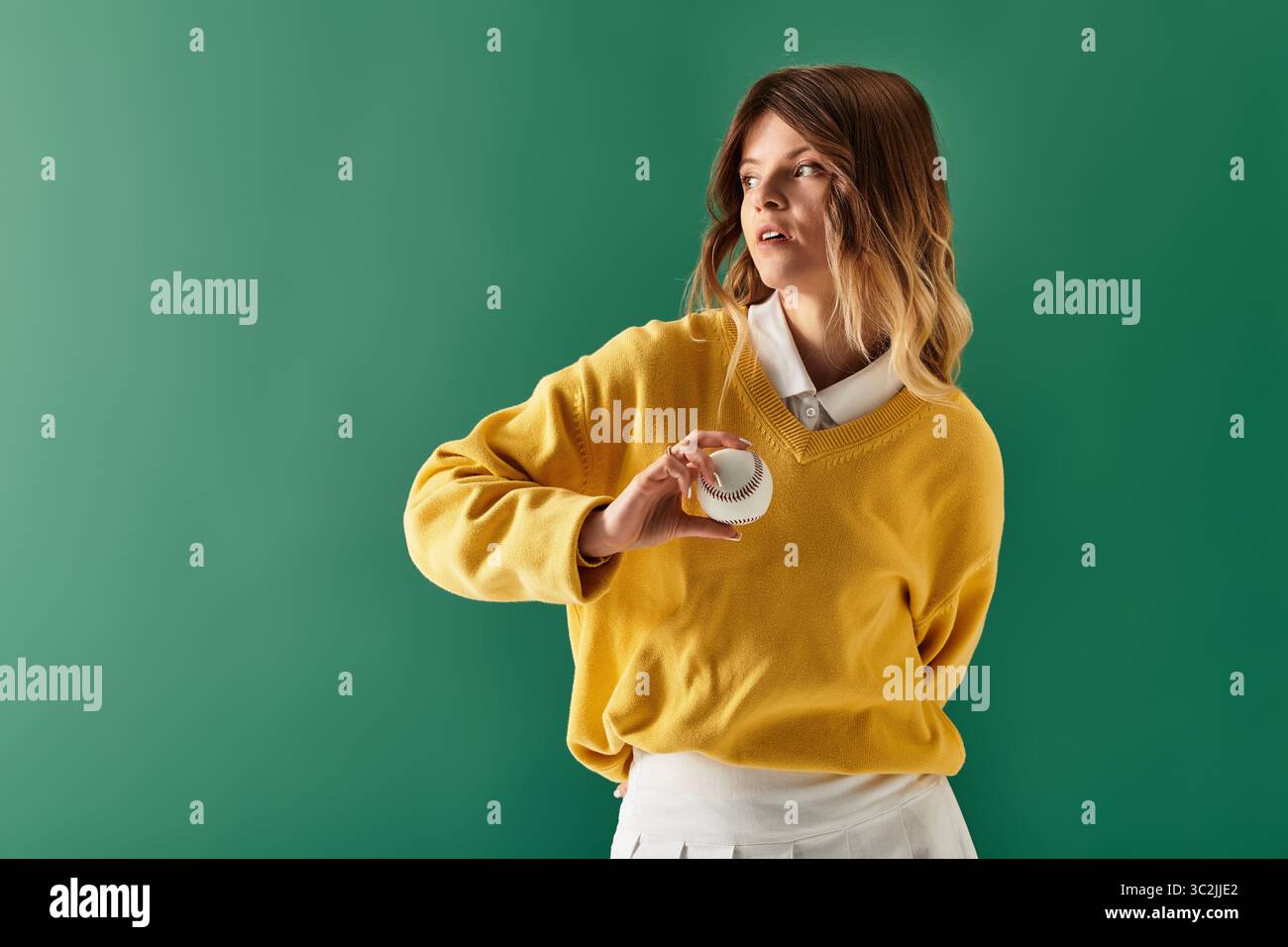 A lovely woman poses with a playful object against a vibrant green ...