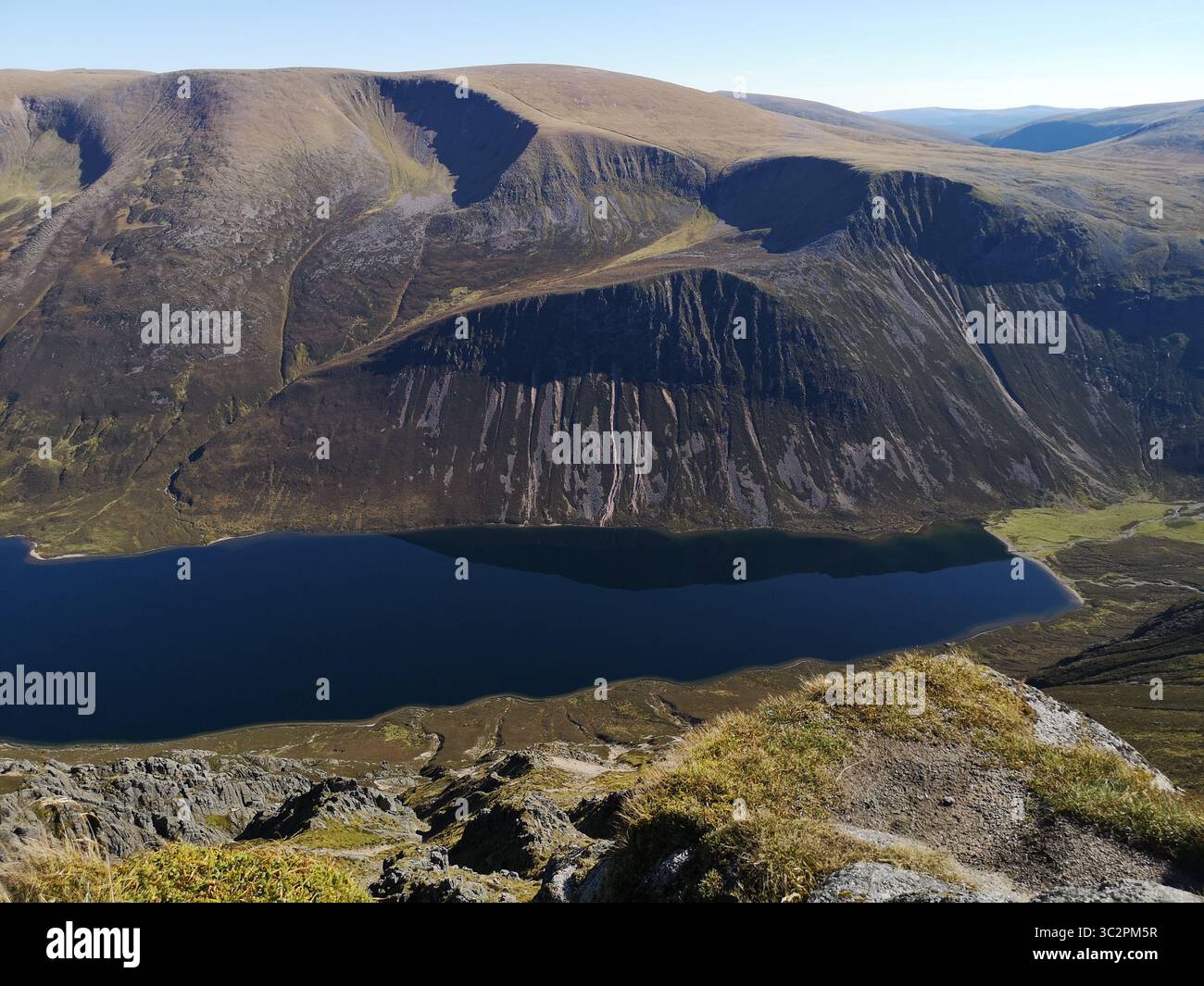 View from Sgòr Gaoith, which is a Munro in the Cairngorms Mountains. Looking over edge of crags to Glen and Loch Einich and over to Braeriach. - Smartphone Captured Stock Image
