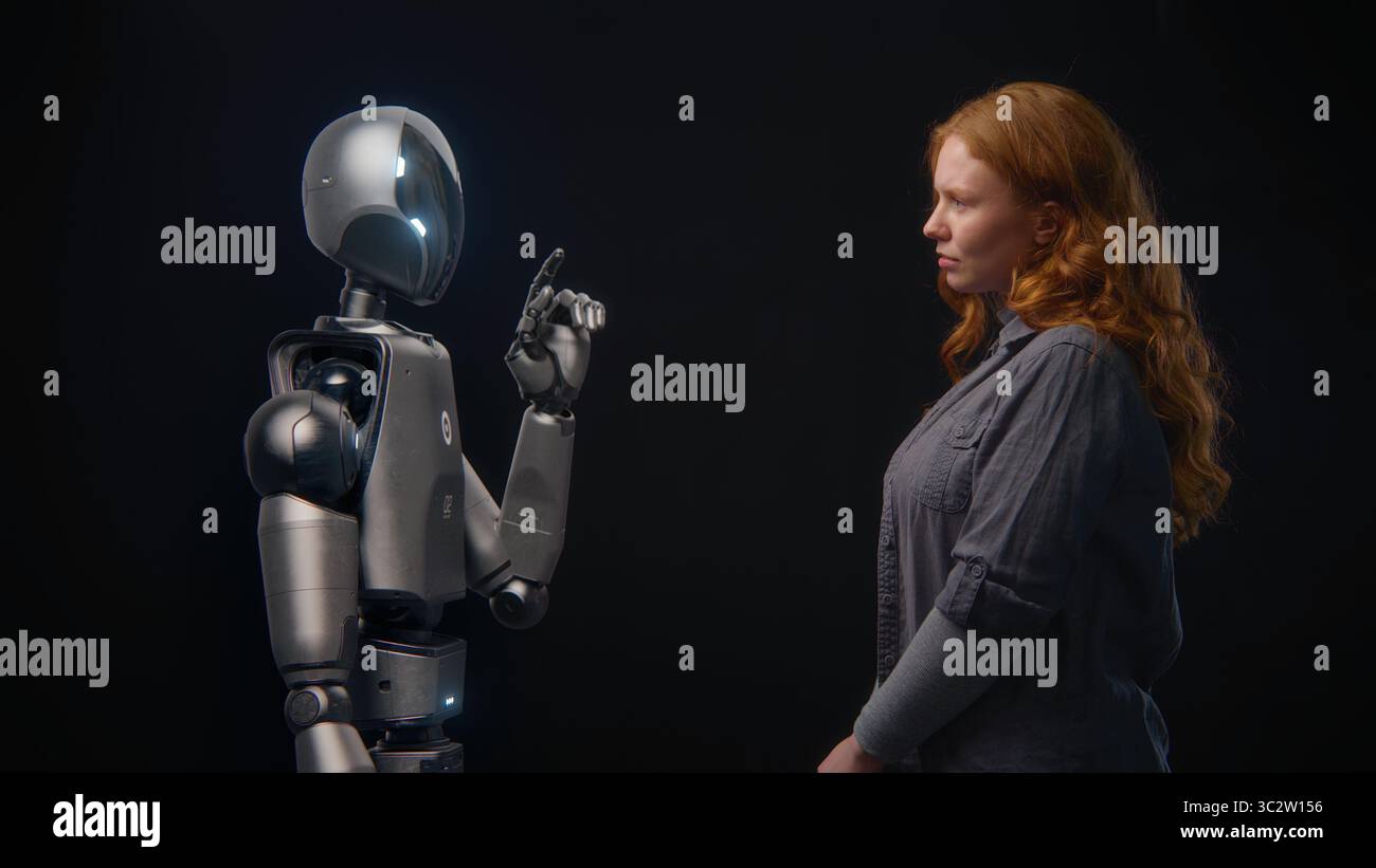 Futuristic Human-Machine Concept: Visualization of Young Woman Speaking with High-Tech Humanoid Robot. Symbol of Connection, Collaboration and Harmony Between Humanity and Artificial Intelligence. Stock Photo