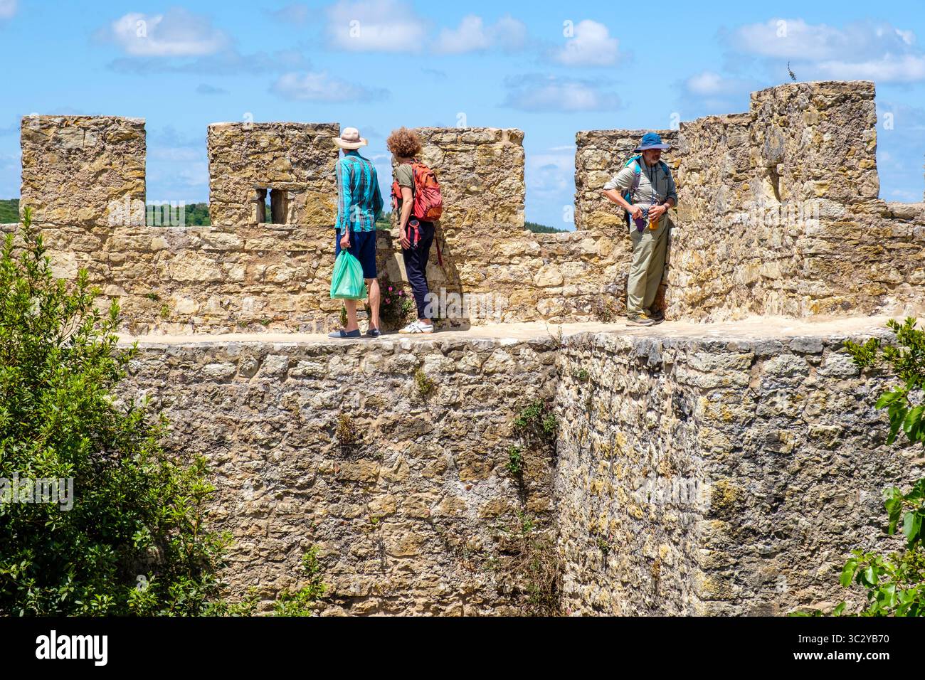 Tourists walking along city of Óbidos castle walls, Portugal Stock Photo