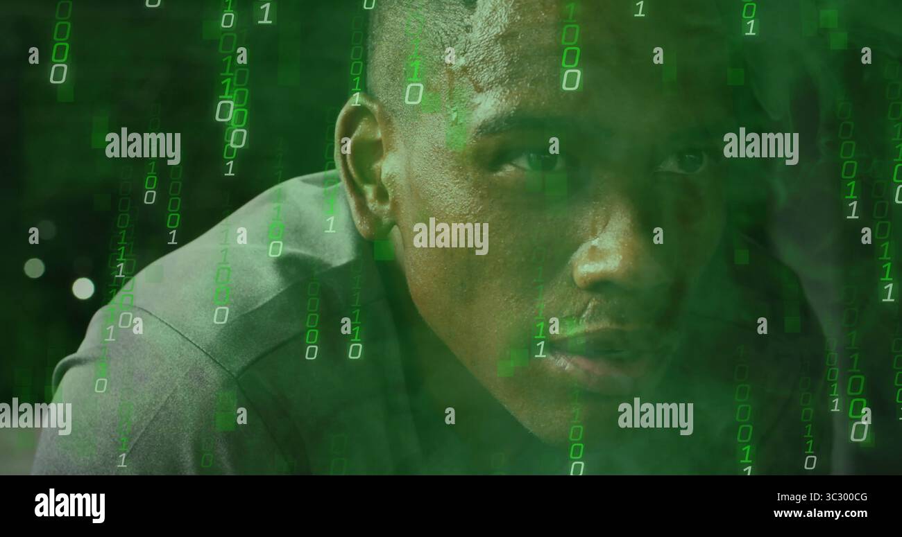 Analyzing code man wearing grey shirt leaning forward in digital scene, with flowing binary digits Stock Photo