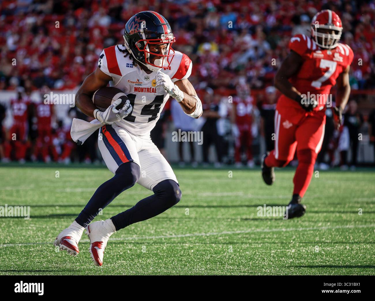 Montreal Alouettes' Charleston Rambo, left, runs with the football as ...