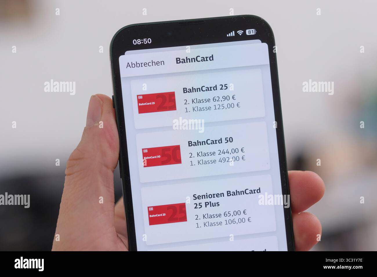 A cell phone shows the various BahnCard options in the Deutsche Bahn app. Symbolic image for digital mobility services and flexible rail travel. Stock Photo