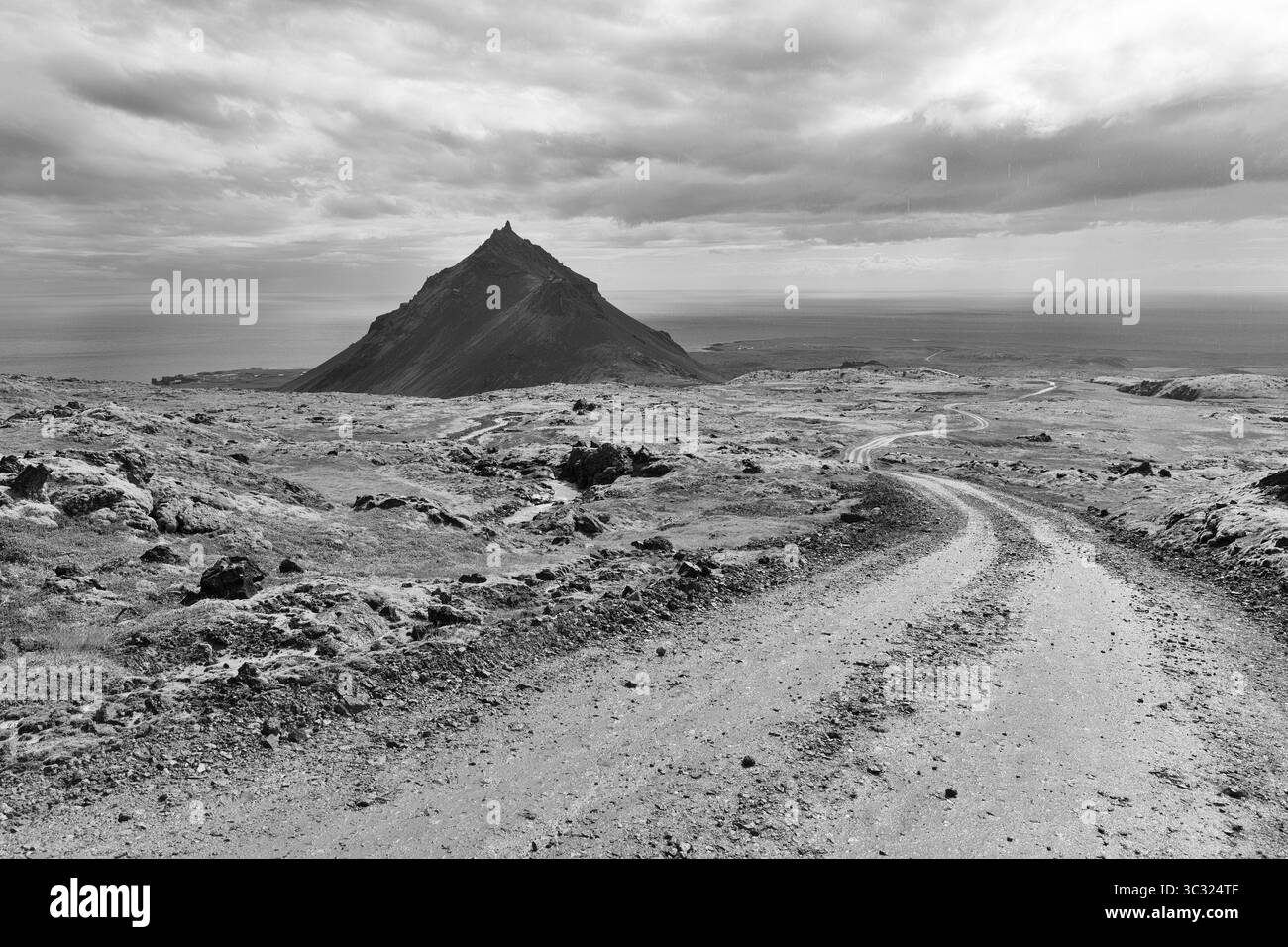 Barren mossy volcanic landscape, cone-shaped mountain Stapafell, monochrome, Arnarstapi, volcanic system Snaefellsjoekull, peninsula, Snaefellsnes, We Stock Photo