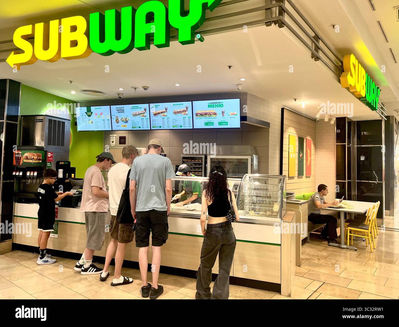 Customers at Subway fast food sandwich shop inside a shopping mall centre in Sofia Bulgaria, Eastern Europe, Balkans, EU - Smartphone Captured Stock Image