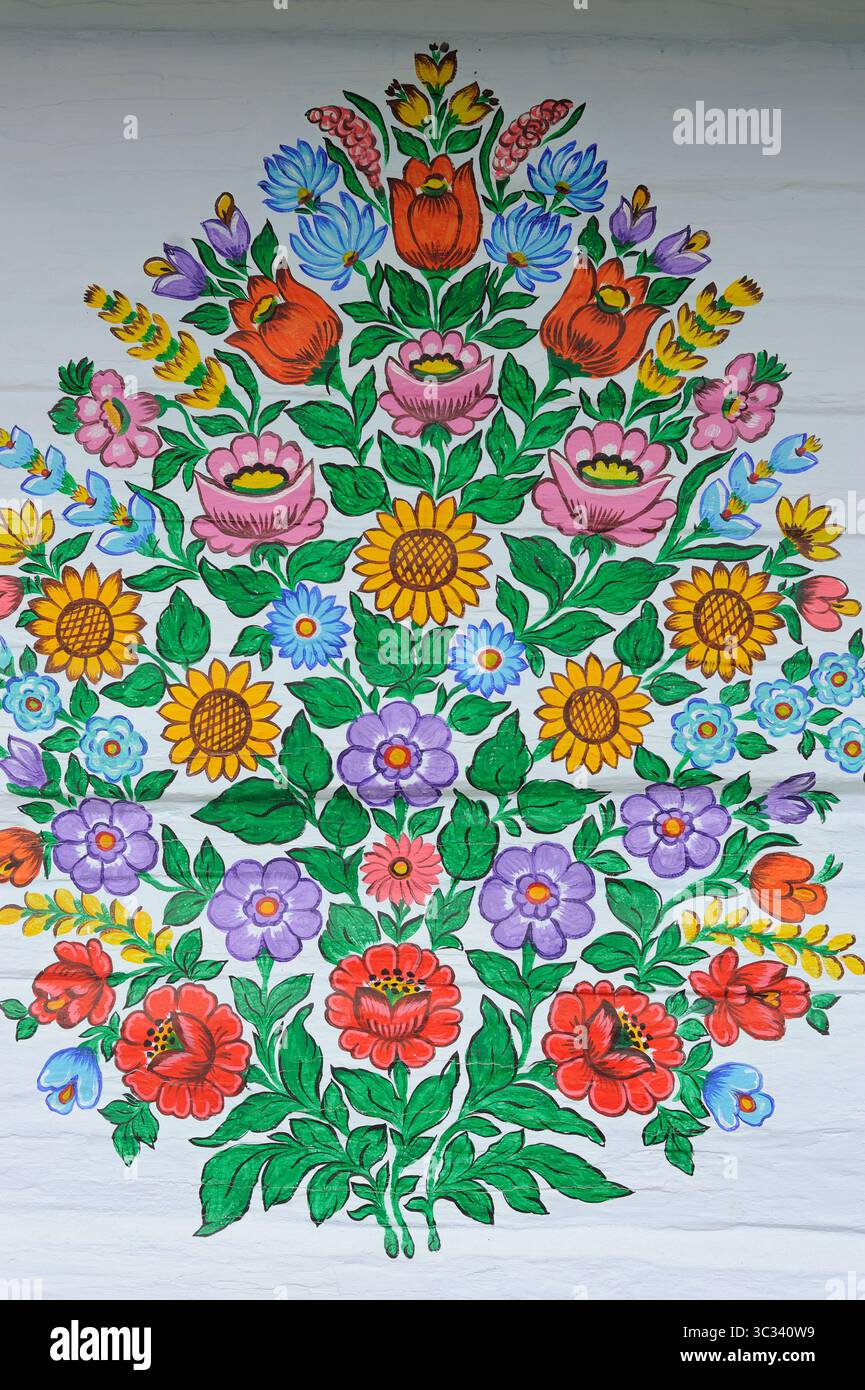 Colorful flower decorative painting of a wreath on wall of an old house handmade and handpainted by local artists in Zalipie Village in Poland Stock Photo