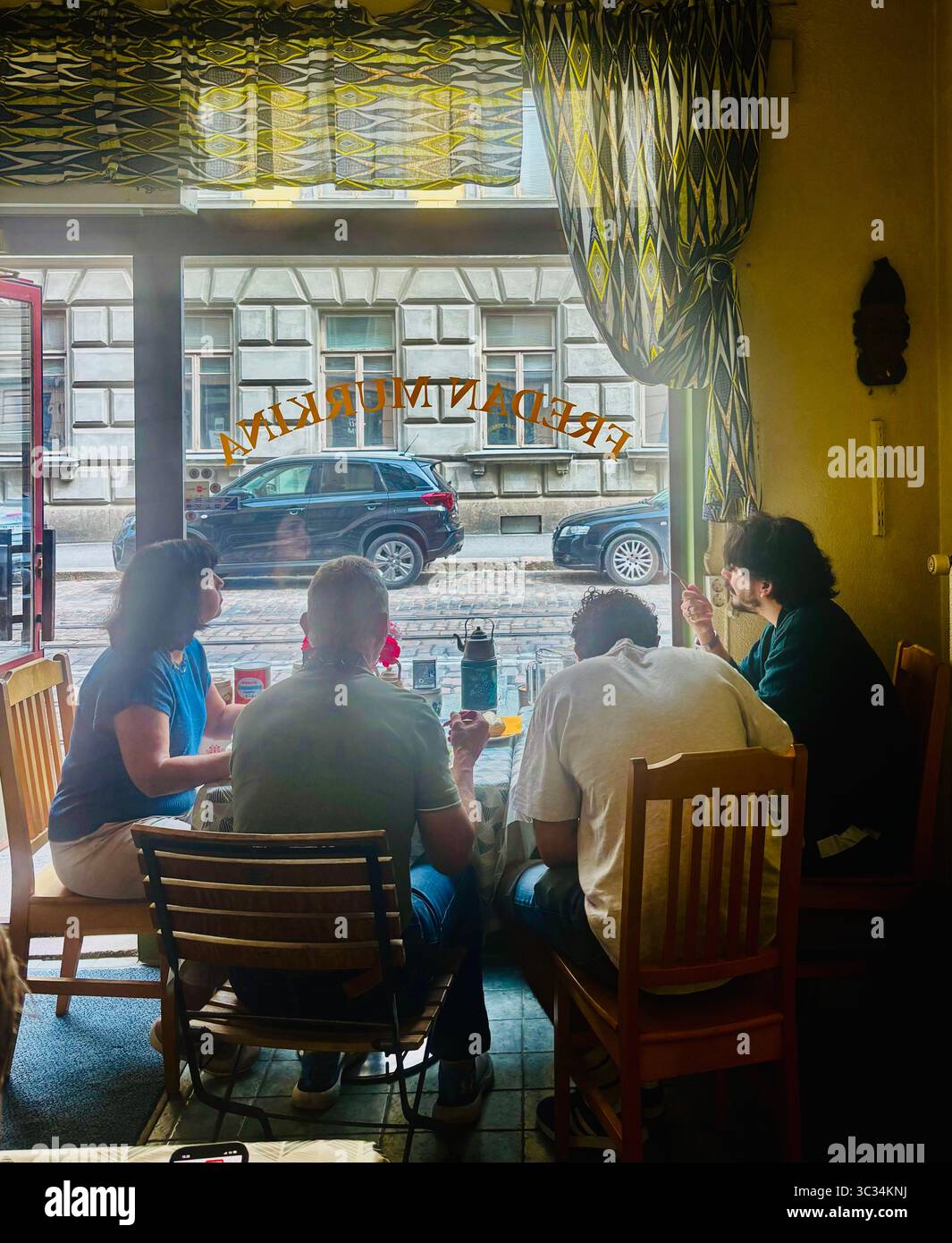 Diners at Fredan Murkina restaruant on Fredrikinkatu street in Helsinki, Finland. - Smartphone Captured Stock Image