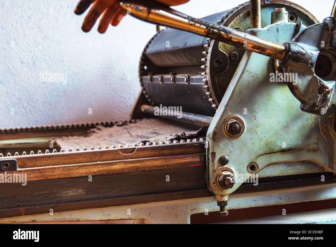 A Detailed Closeup Of A Traditional Manual Printing Press With Visible