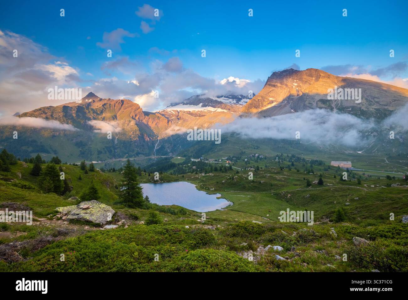 View of the Hopschusee lake at the top of the Simplon pass at sunset in summer. Simplonpass, Canton of Valais, Switzerland. Stock Photo