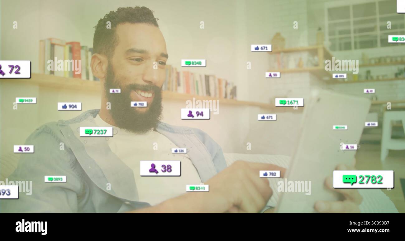Scrolling bearded man holding tablet on couch in modern living room ...