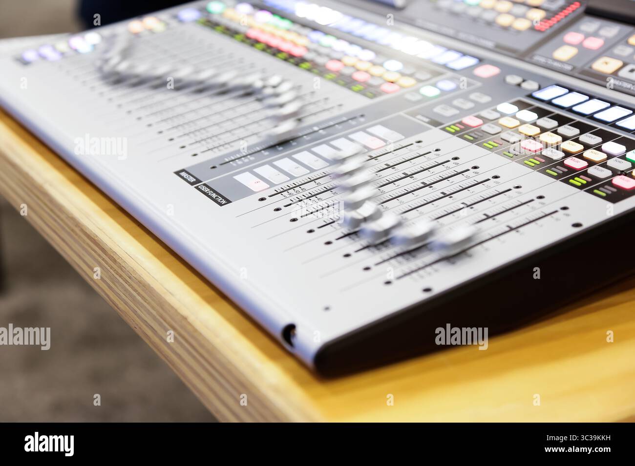 Anaheim, California, United States - 01-19-2020: A view of a pre-programmed mixer console faders automatically moving in wave forms. Stock Photo
