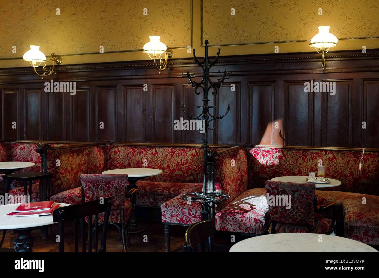 Vienna, Austria: Interior of Café Sperl with iconic red velvet bench used in Before Sunrise—a classic setting of Viennese café culture, rich in charm. Stock Photo