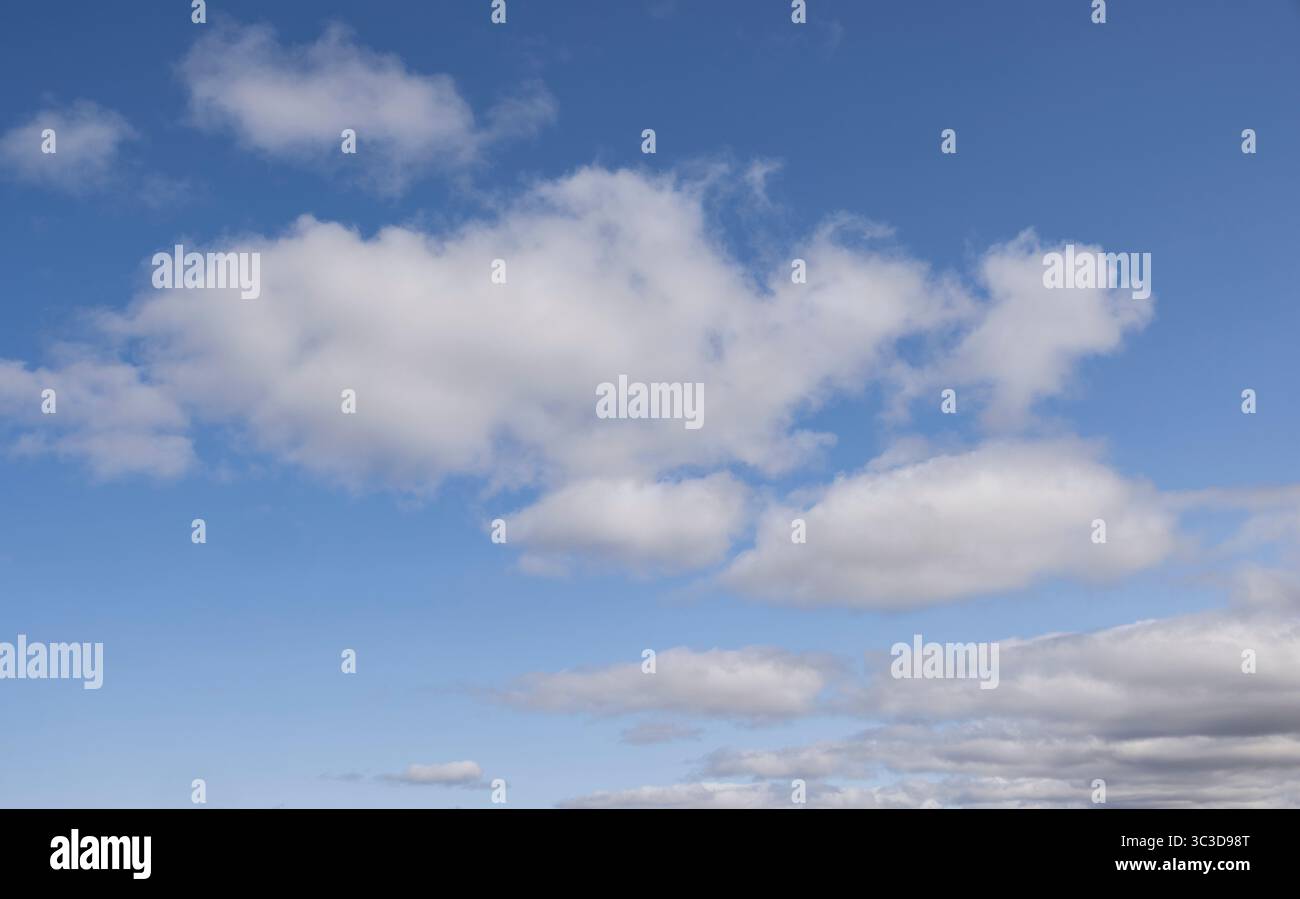 Blue sky with fluffy white clouds Stock Photo