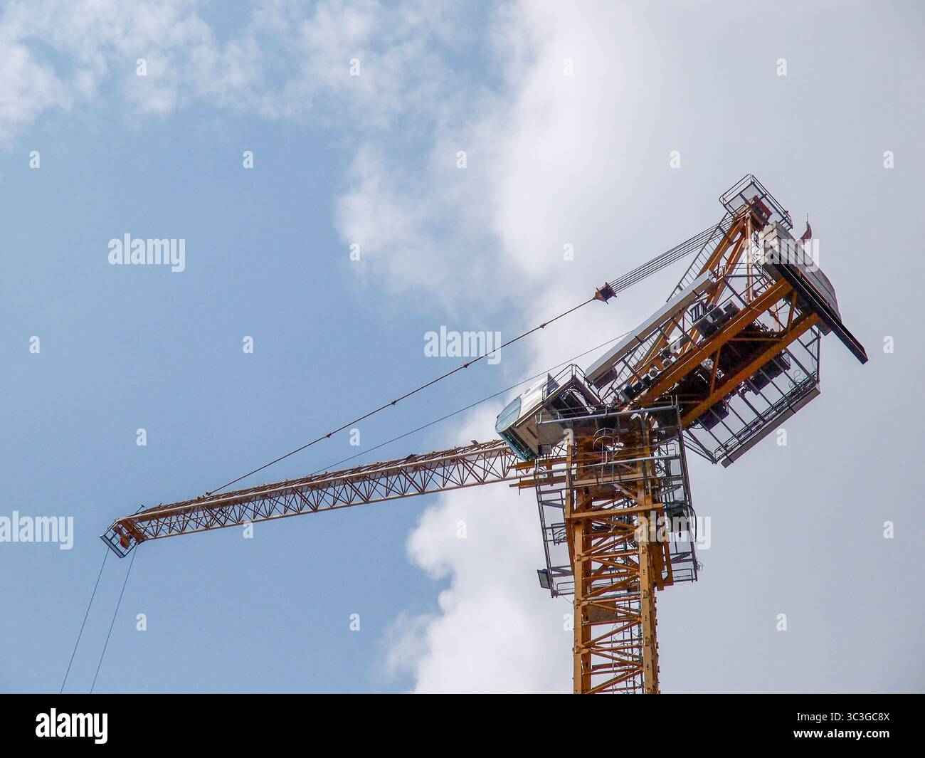 Jib crane tower against blue sky Stock Photo - Alamy