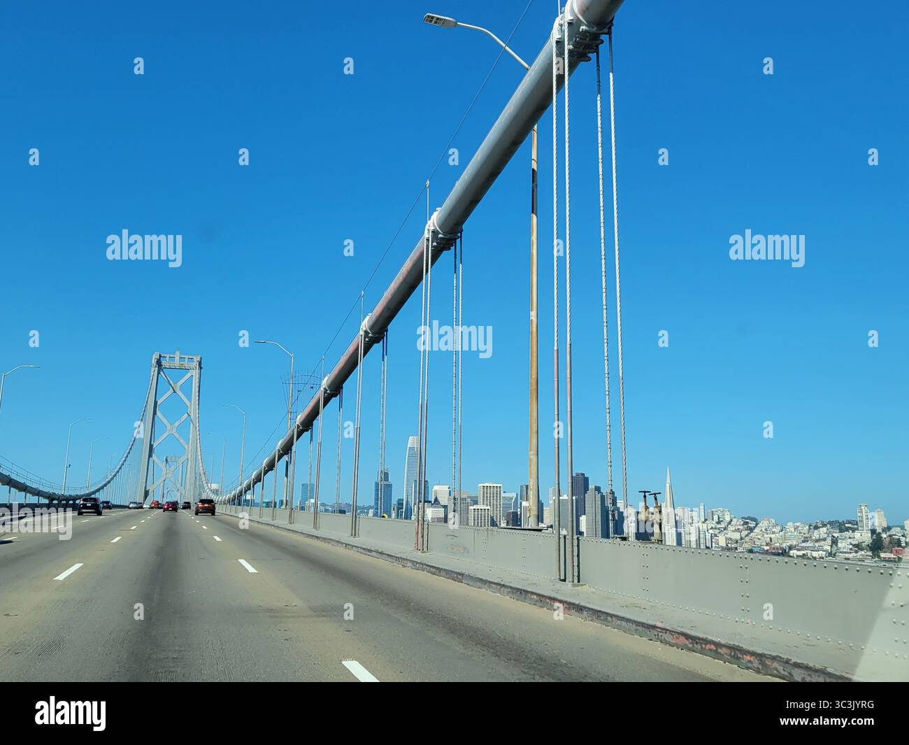 Crossing the iconic Golden Gate Bridge into San Francisco California under a  crystal clear blue sky. - Smartphone Captured Stock Image