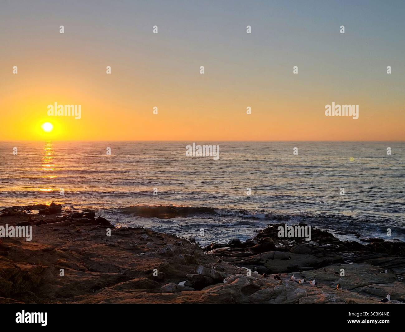 The sun sets over the Pacific ocean along the California coastline - Smartphone Captured Stock Image