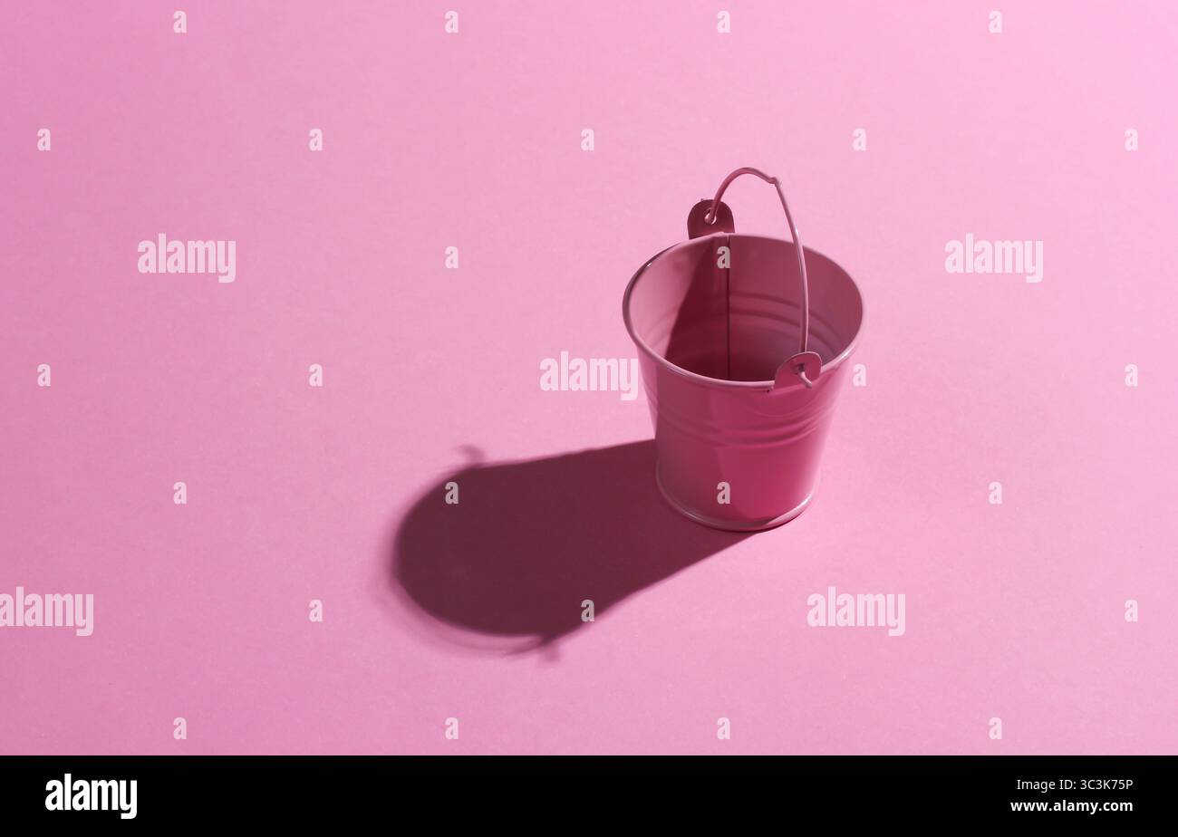 Empty mini pink bucket on pink background. Studio shot with shadow Stock Photo