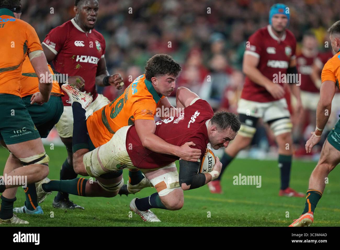 Jack Conan of the British & Irish Lions, right, is tackled by Australia ...