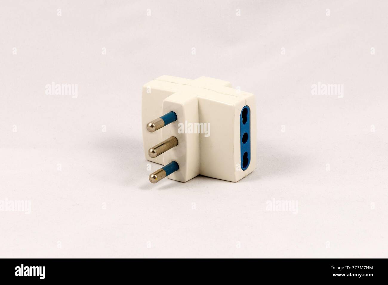 Three way EU electric plug adaptor, isolated on white background Stock Photo