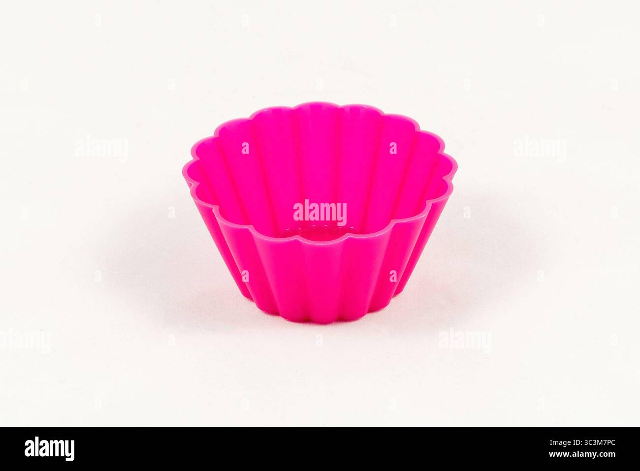 Pink silicone cake cups isolated on white background Stock Photo