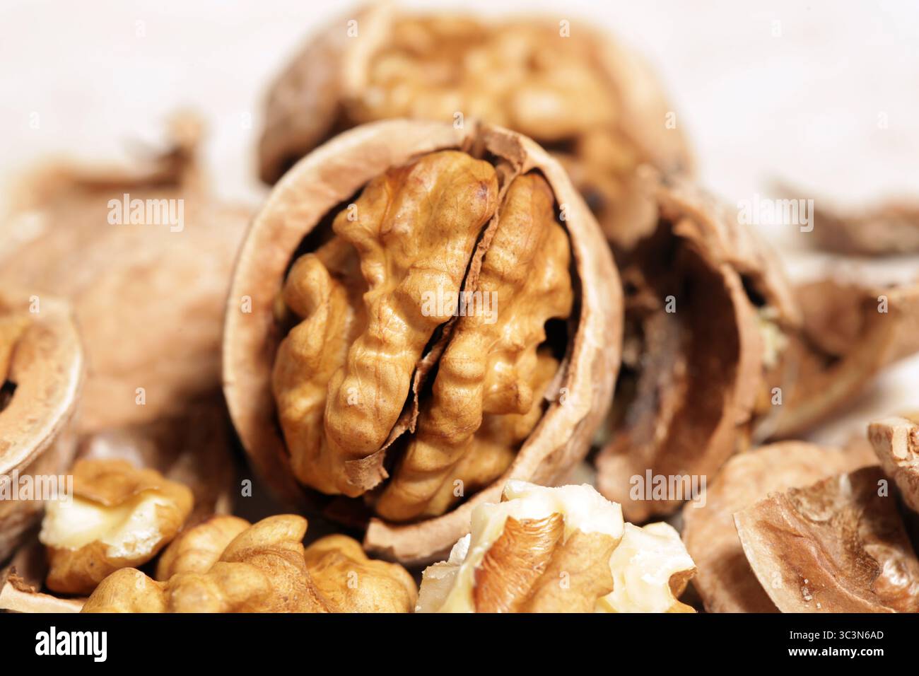 Whole and cracked walnuts and nutcracker Stock Photo