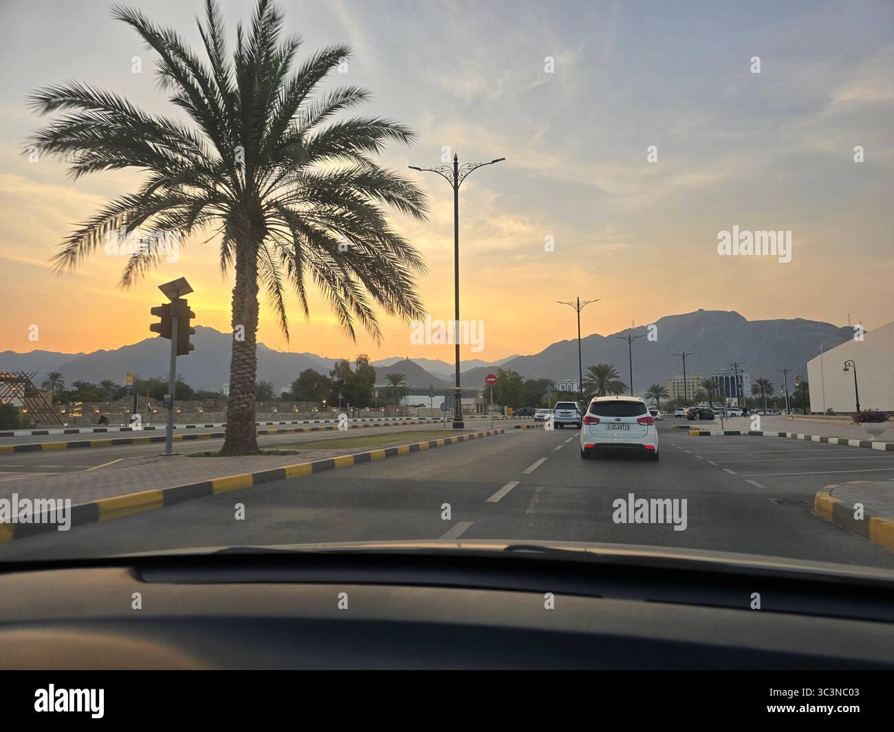 Golden desert dunes with mountains in the distance under clear blue sky - Smartphone Captured Stock Image