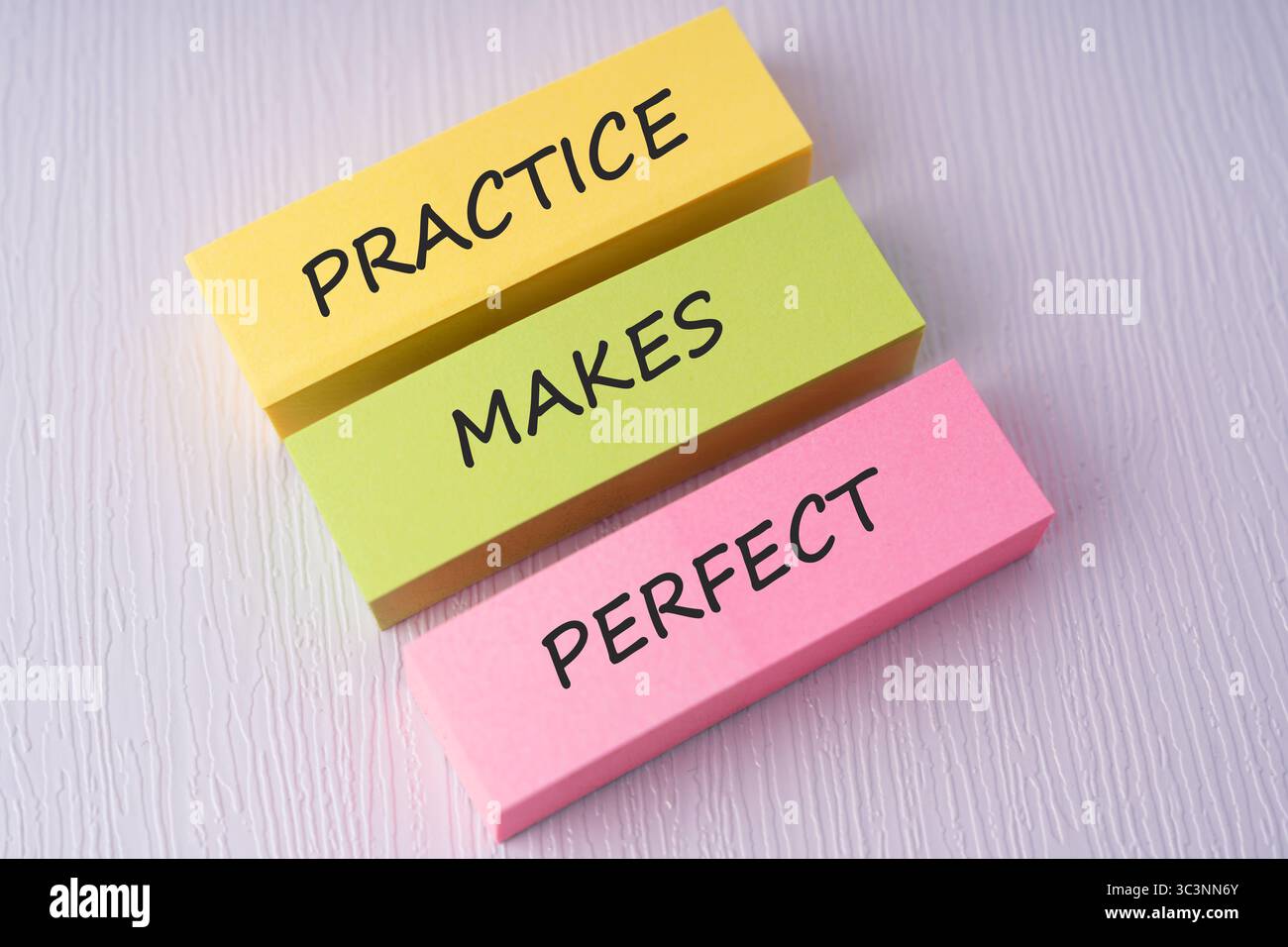 Colorful sticky notes with text practice makes perfect on white background Stock Photo