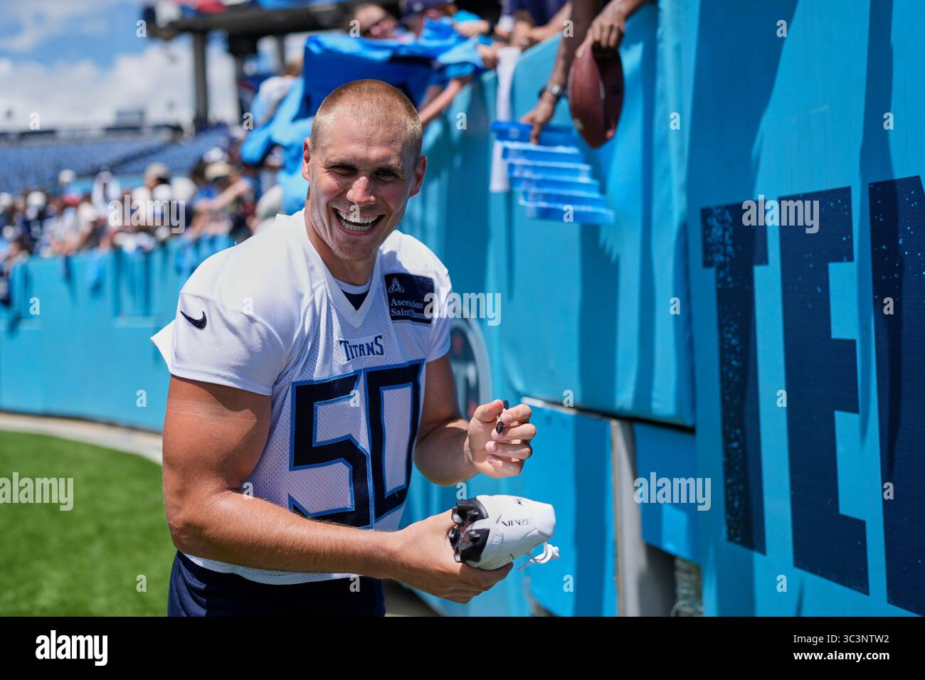 Tennessee Titans linebacker Cody Barton (50) laughs as he signs ...