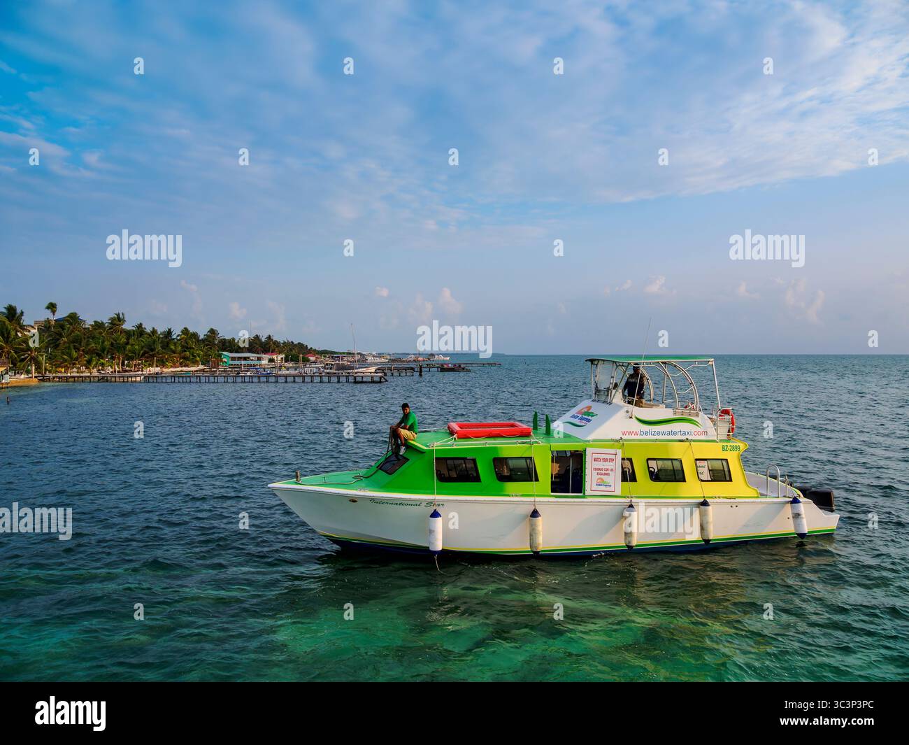 Ferry boat arriving to Caye Caulker, Belize District, Belize Stock Photo