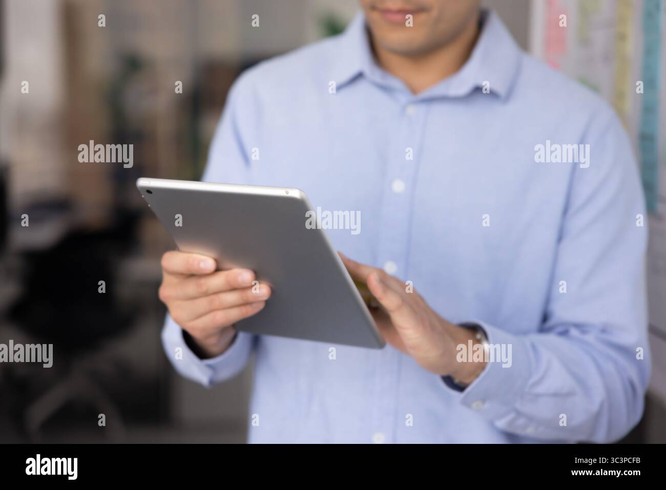 Close up businessman working on digital tablet Stock Photo