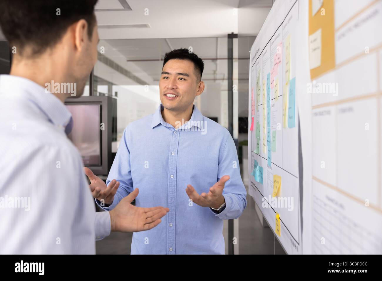 Two diverse professional men, project managers working on task Stock Photo