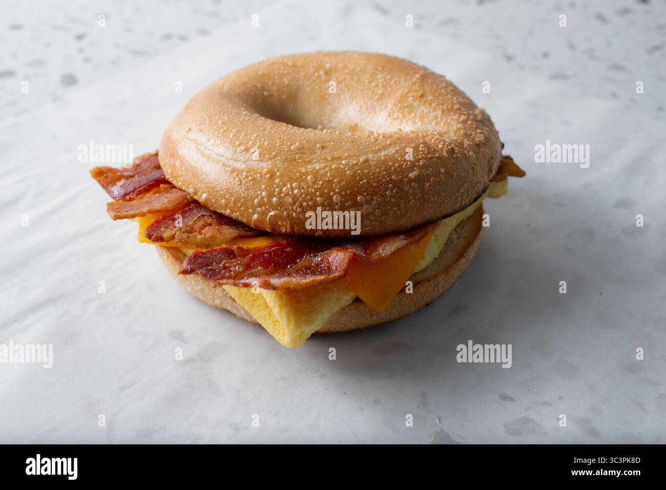 A view of an egg bacon and cheese bagel sandwich Stock Photo - Alamy